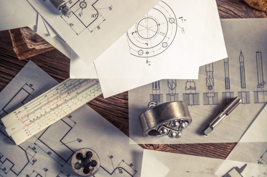 Designer desk of mechanical parts on old wooden table